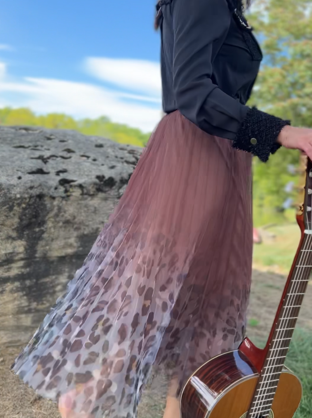 Brown pleated mesh skirt with a chic leopard print hem, perfect for adding style to any outfit.