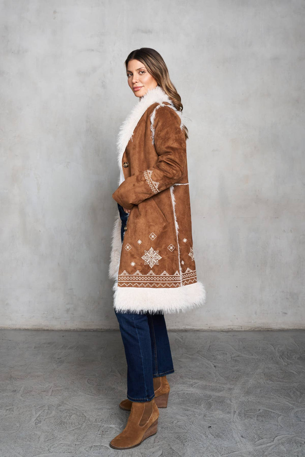 Faux suede camel coat with shearling trim, featuring delicate embroidery on the front and back, and mid-length design.