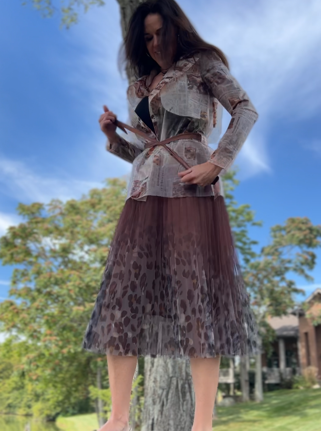 Brown pleated mesh skirt with a chic leopard print hem, perfect for adding style to any outfit.