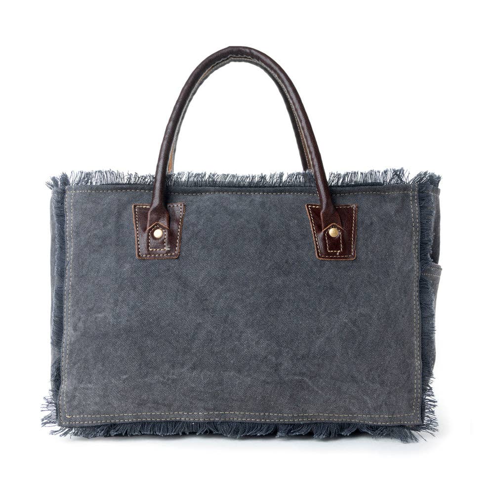 Rectangular gray bag with frayed edges, two handles, and visible stitching, showcasing the Articulate Canvas & Hairon design.