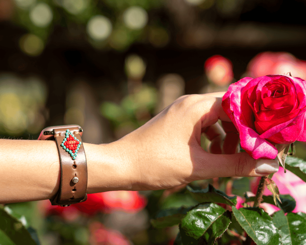 A stylish Biarritz Beaded Apple Watch Band featuring a red and turquoise design, perfect for adding a western flair to your look.