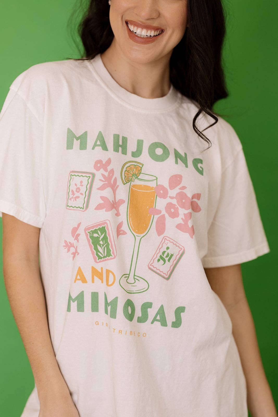 Light-colored Mahjong and Mimosas Tee featuring a fun graphic design with cocktails and floral elements, perfect for casual wear.