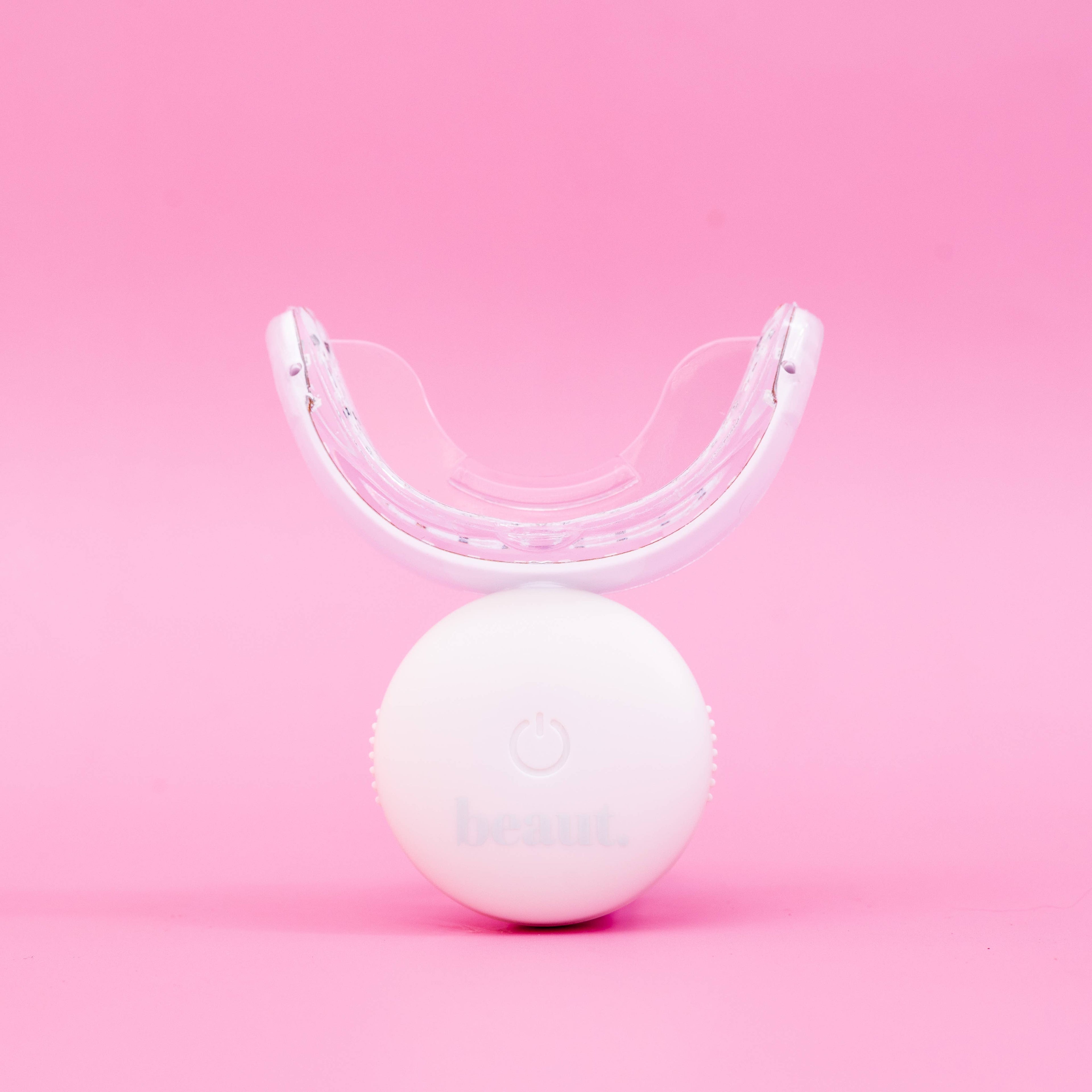 Curved transparent mouthpiece with a grid-like structure, part of the Cozy Kit dental device for whitening and oral care.