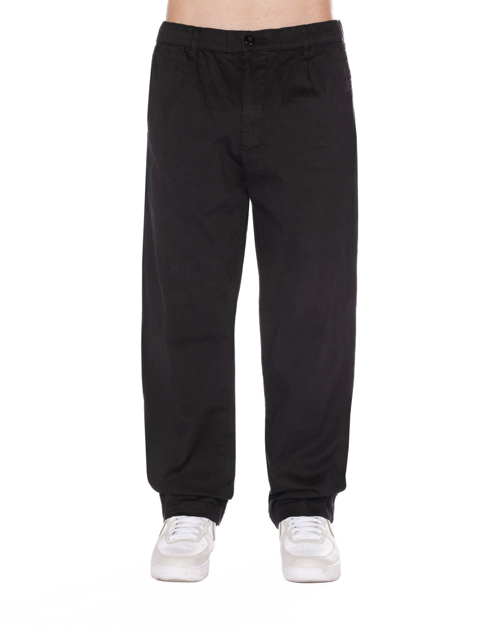 Relaxed fit black pants featuring a pleated front, elastic waistband with drawstring, and styled for a casual look.
