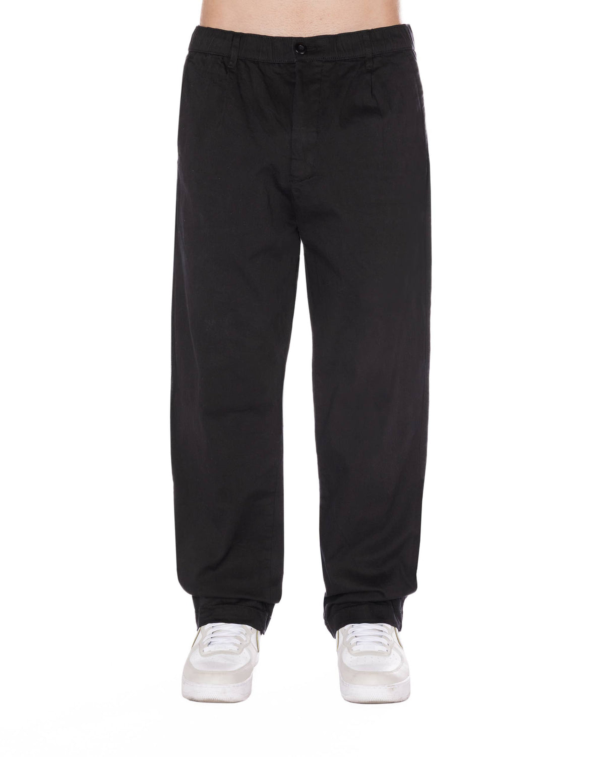 Relaxed fit black pants featuring a pleated front, elastic waistband with drawstring, and styled for a casual look.
