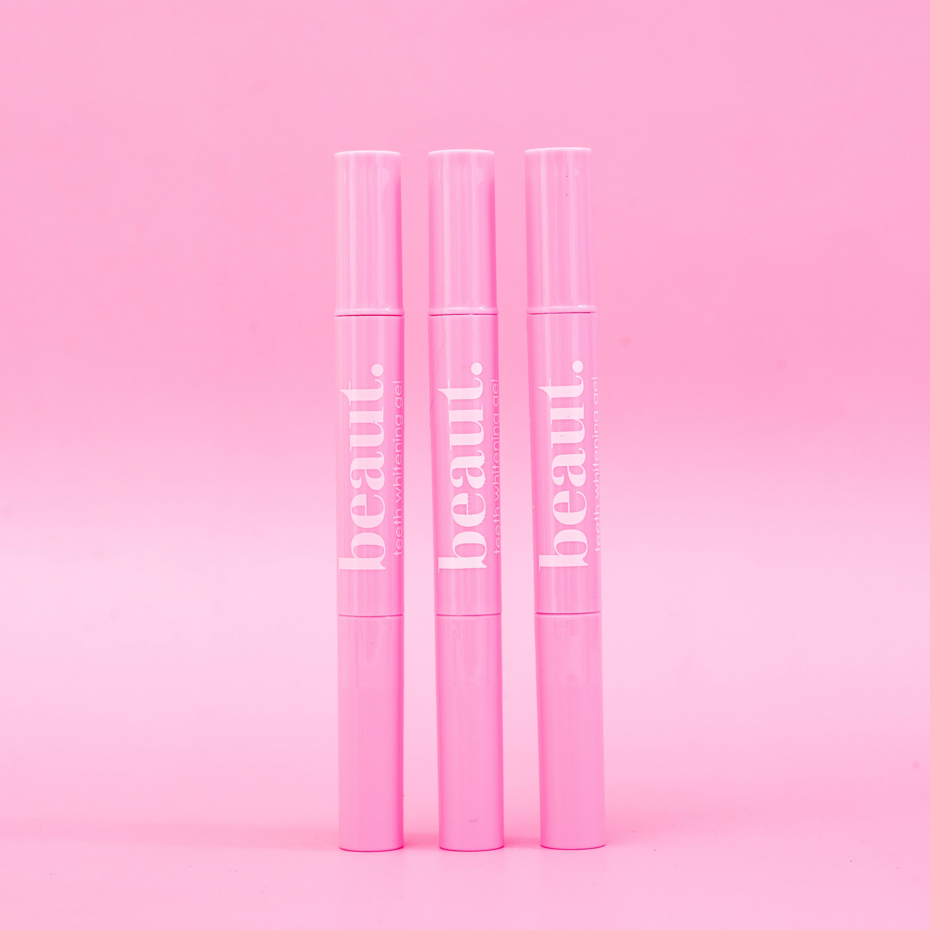 Three pink applicator pens labeled 'beaut.' arranged vertically, showcasing the vibrant color of the Polly Pink Kit.
