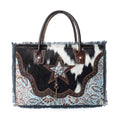Stylish Articulate Canvas & Hairon Bag featuring a star design, fringe detail, and a mix of black, white, light blue, and brown accents.