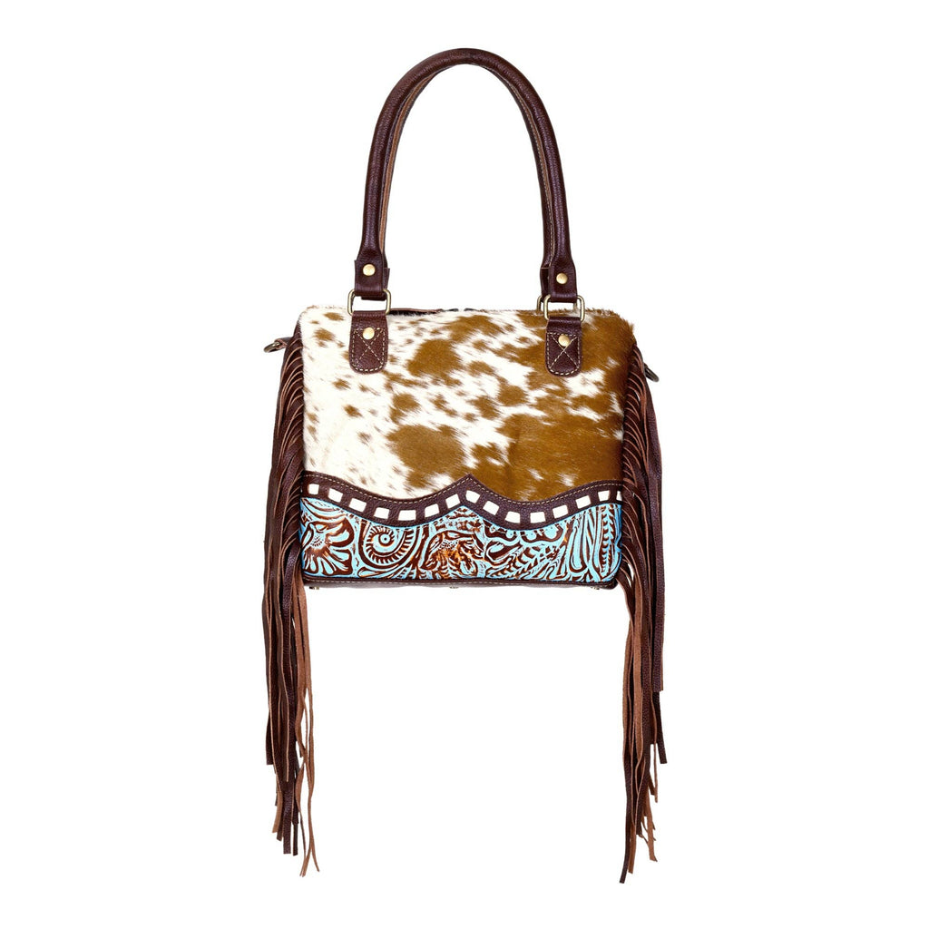 Chic brown hairon leather concealed carry bag with fringe detailing and adaptable straps for versatile carrying options.