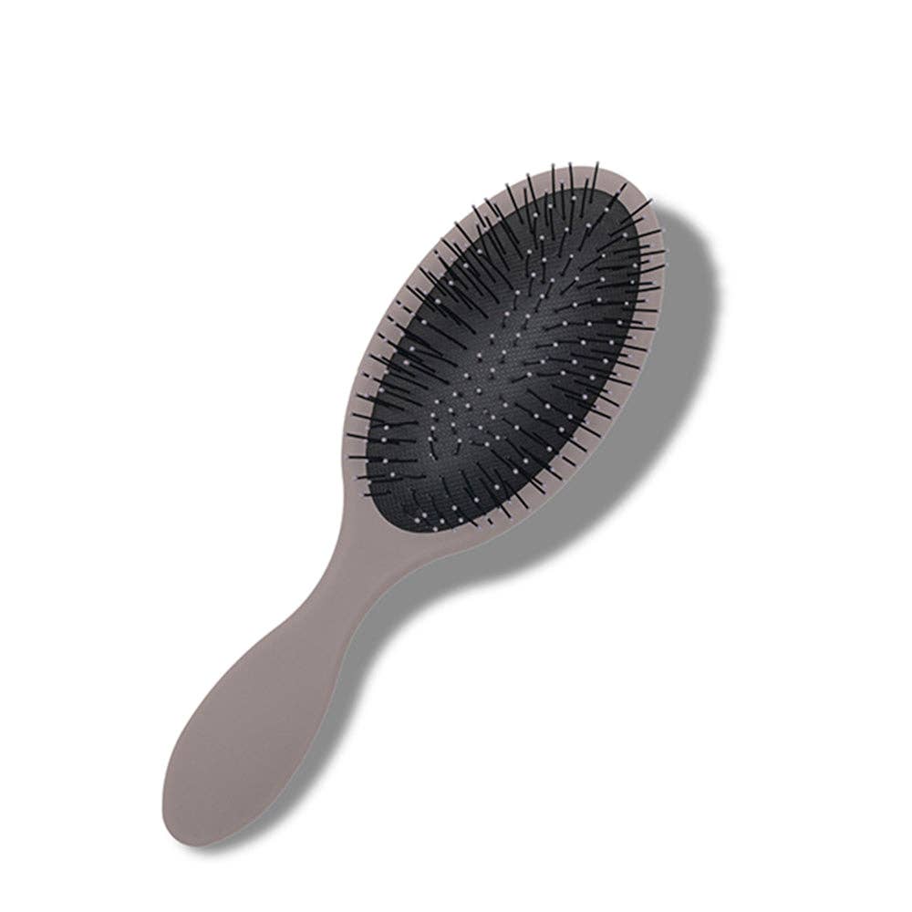 Oval-shaped hairbrush with a sturdy cloud gray handle and full black bristles, featuring unique designs on the back.