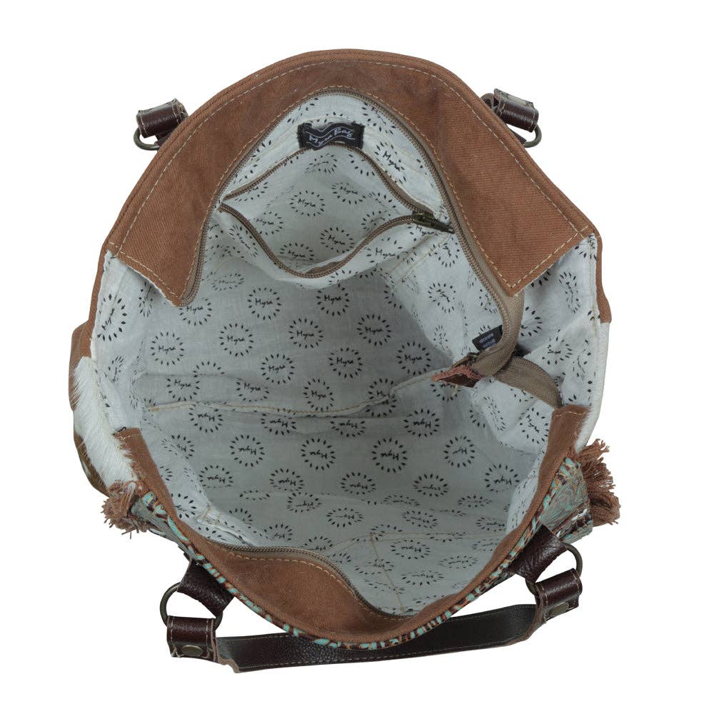 Amethyst Canvas & Hairon Pouch featuring a zip closure, patterned lining, and a mix of textures for stylish organization.