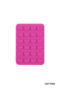 Hot pink silicone suction cup phone holder with multiple suction cups arranged in a grid pattern, perfect for hands-free use.