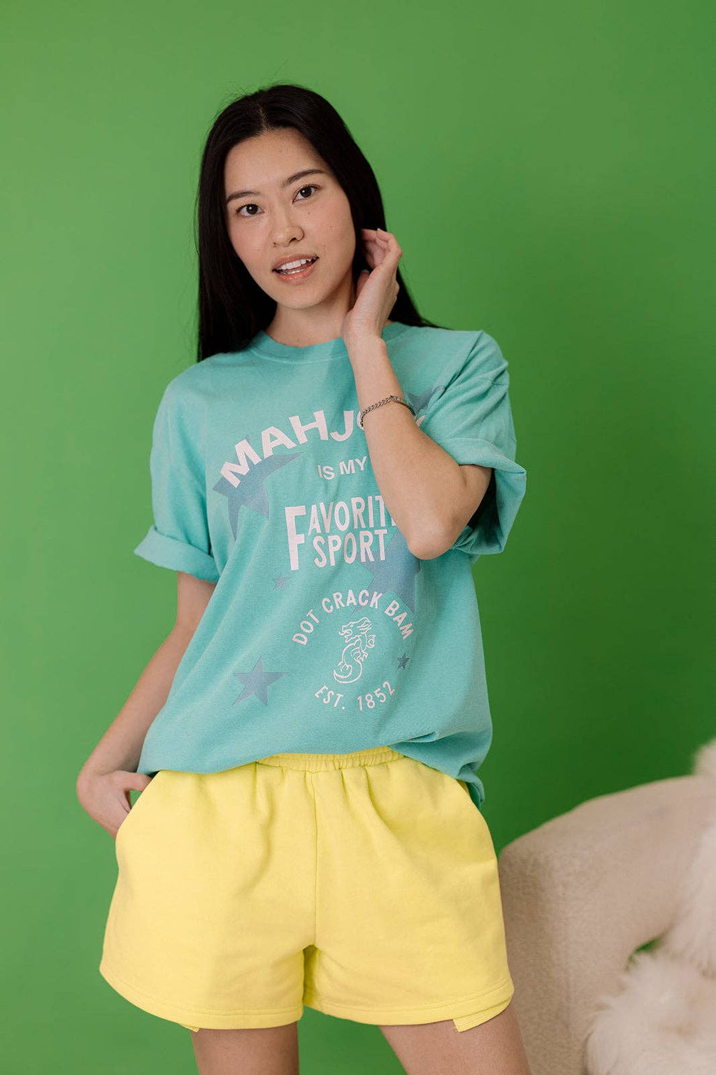 Turquoise relaxed-fit tee featuring the text 'MAHJONG is My Favorite Sport' in a playful design. Perfect for casual wear.