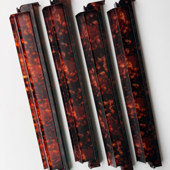 Set of four mahjong racks featuring a glossy tortoise shell pattern in dark browns and amber tones, designed for smooth gameplay.