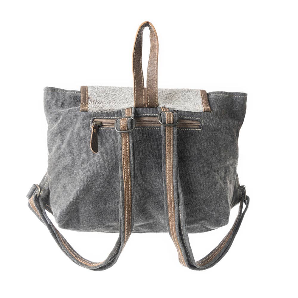 Minimalist grey backpack with a leather flap, adjustable straps, and a top handle for easy carrying.
