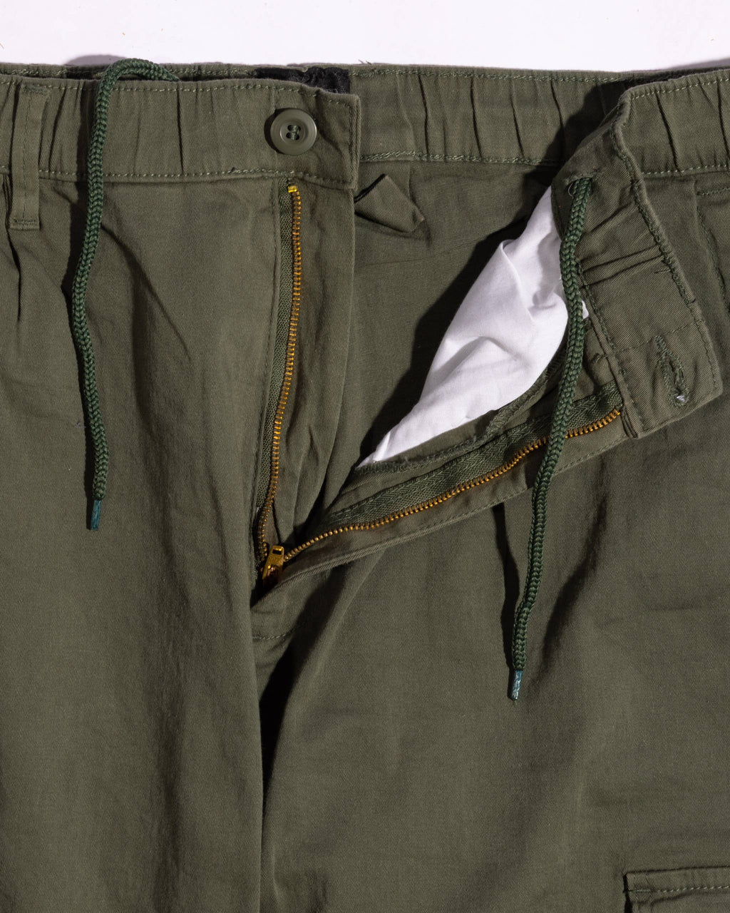 Relaxed-fit cotton cargo pants featuring an elastic drawstring waistband, zip fly, and multiple pockets for practicality.