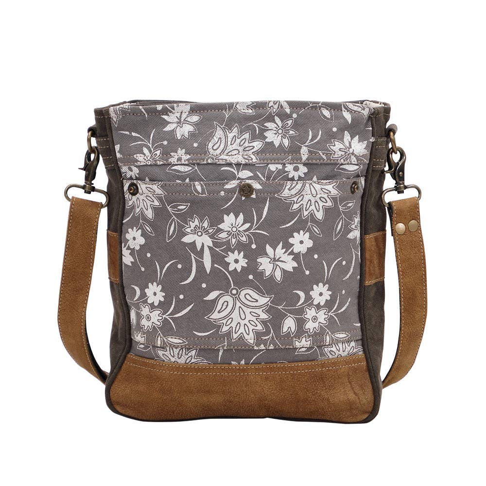 Blossom print shoulder bag featuring floral patterns, a shoulder strap, and multiple front compartments in shades of gray and brown.