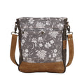 Blossom print shoulder bag featuring floral patterns, a shoulder strap, and multiple front compartments in shades of gray and brown.