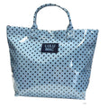 Light blue tote bag with playful black dot design and two handles, featuring a visible 'LULU MAC' label on the front.