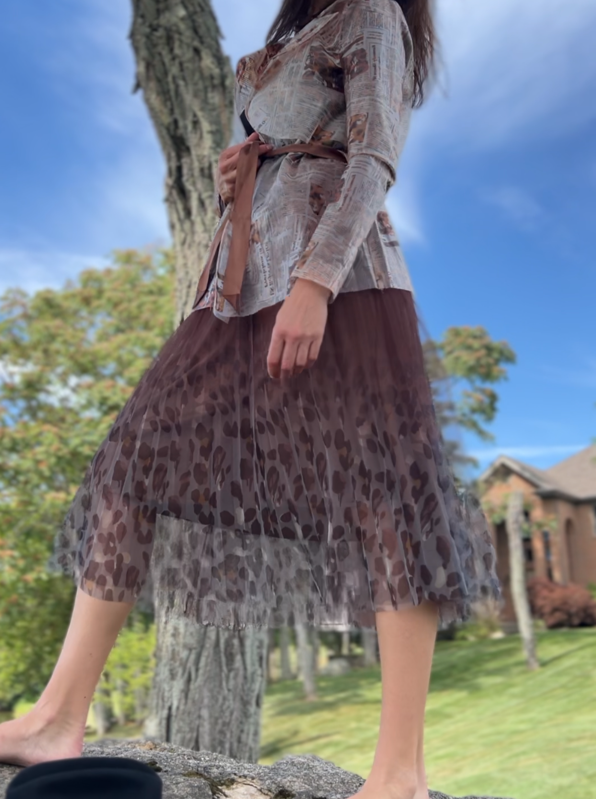 Brown pleated mesh skirt with a chic leopard print hem, perfect for various occasions and designed to fit sizes S to L.