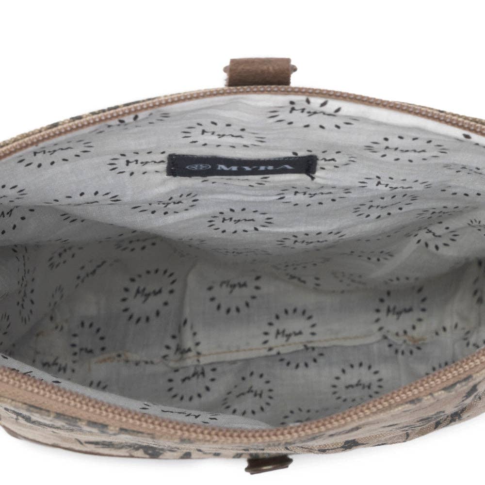Floral canvas crossbody bag featuring a fold-over flap and zipper closure, with a patterned interior lining.