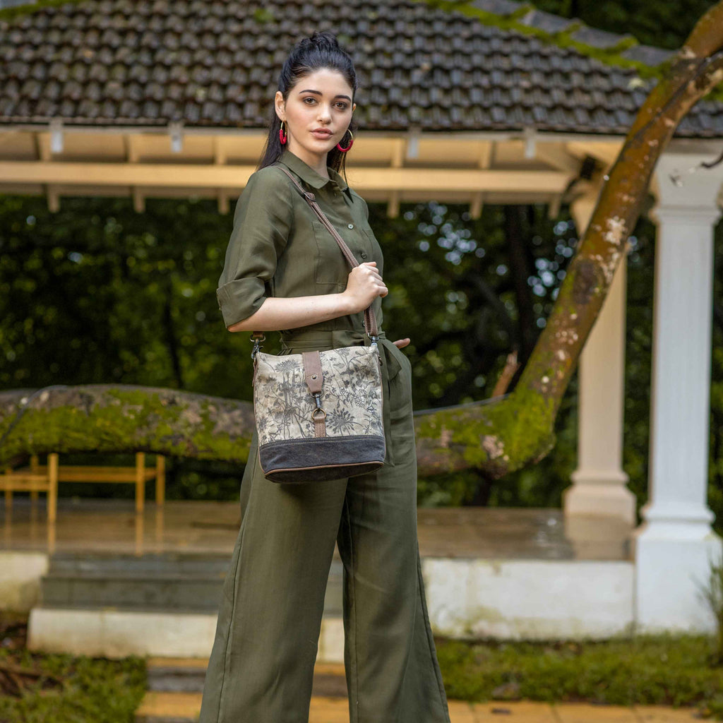 Debonair Shoulder Bag featuring a stylish front lock closure and adjustable leather straps in a chic canvas print design.