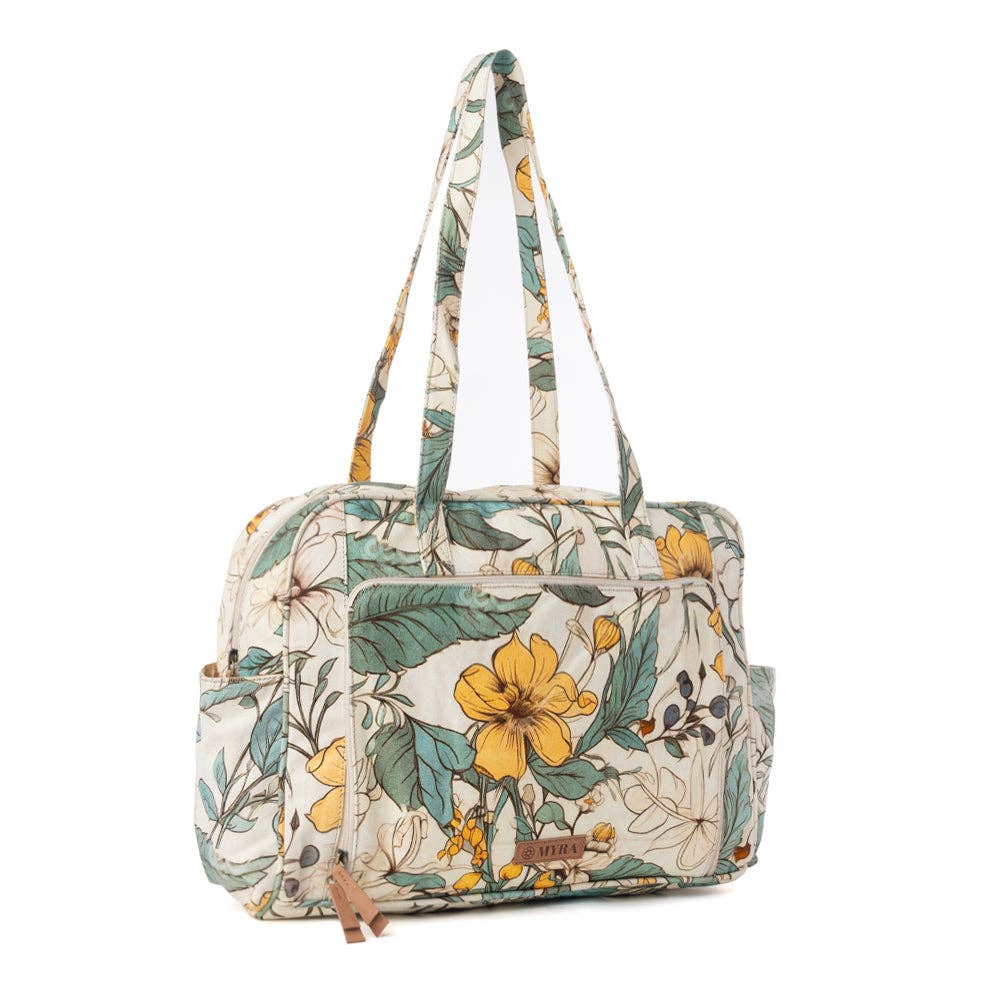Vintage-inspired floral diaper bag in ochre and green tones with spacious main compartment and sturdy handles.