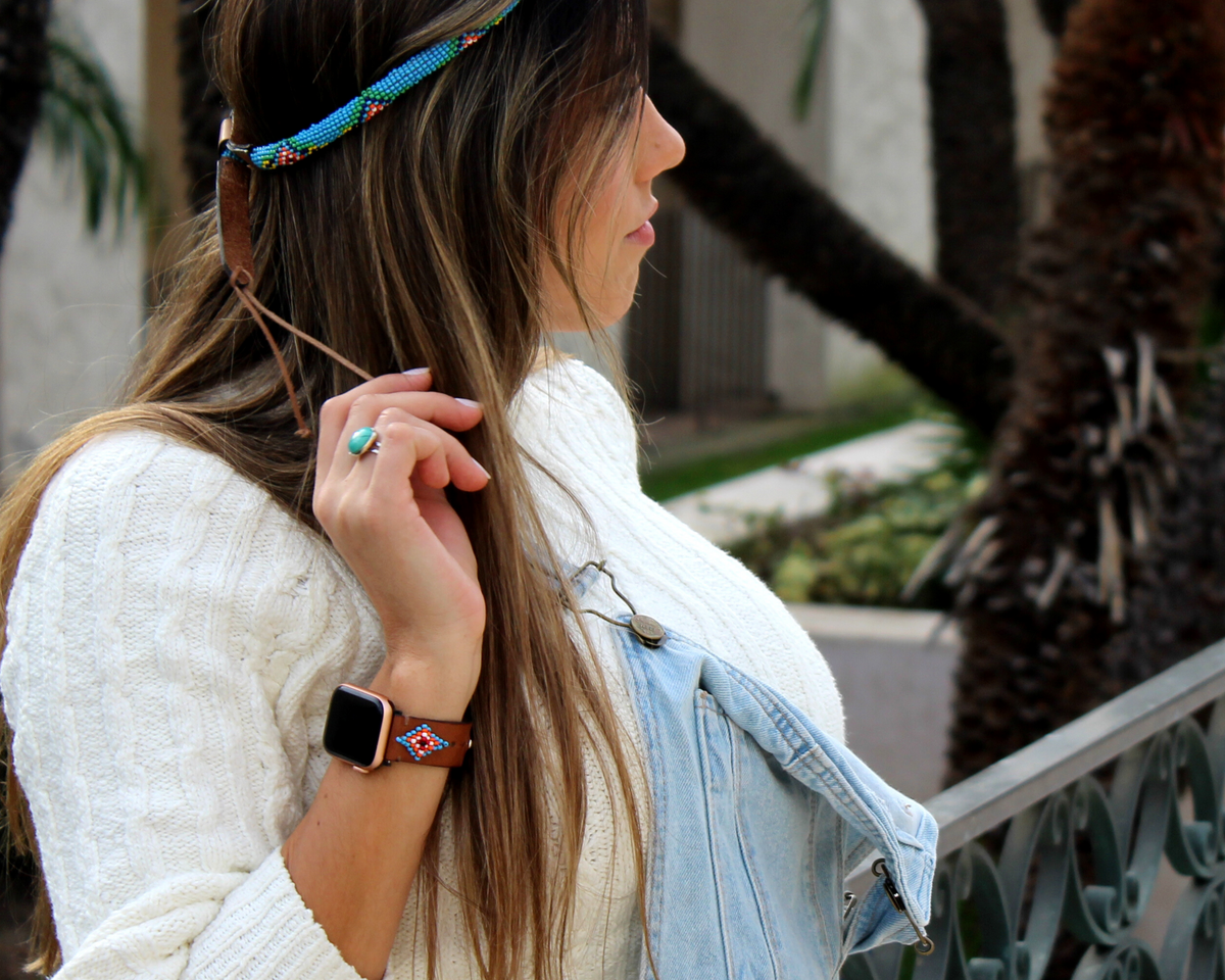 A woman wears a colorful Blue Vogue Beaded Apple Watch Band featuring a western-inspired design with glass beads.