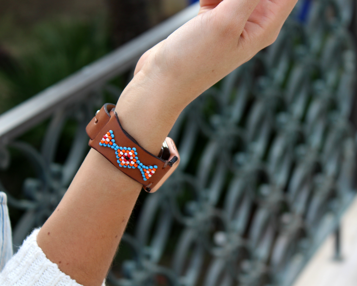 Beaded leather Apple Watch band featuring a western design with orange, blue, and white glass beads.
