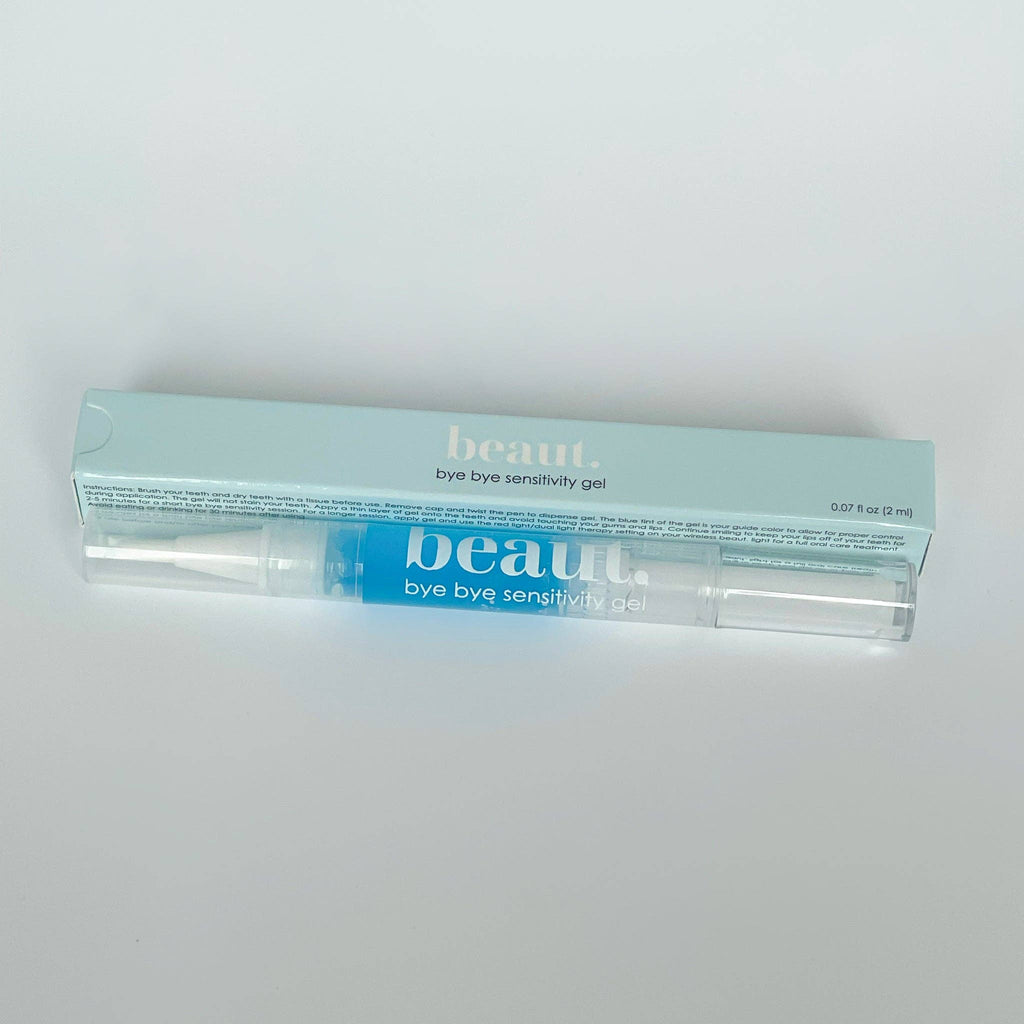 Transparent gel pen with blue gel inside, packaged in a light blue box labeled Bye Bye Sensitivity Gel.