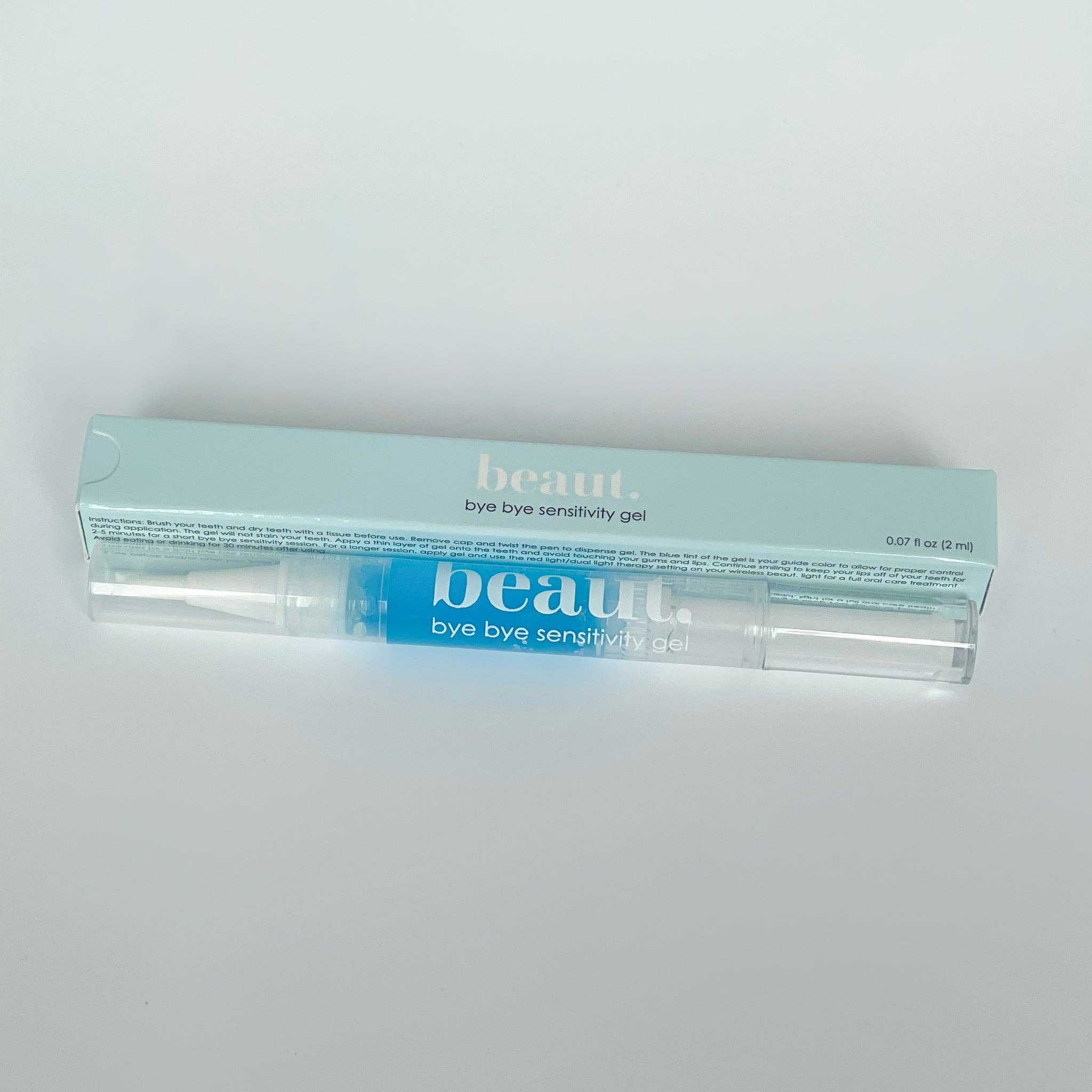 Transparent gel pen with blue gel inside, packaged in a light blue box labeled Bye Bye Sensitivity Gel.