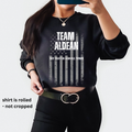 Graphic sweatshirt featuring 'TEAM ALDEAN' and 'TRY THAT IN A SMALL TOWN' with a flag motif and rolled sleeves.