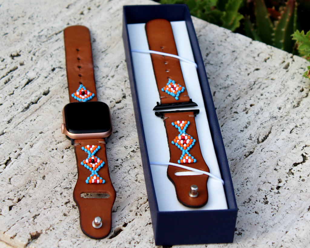 Leather Apple Watch band featuring a symmetrical beaded design with blue, orange, and white beads, perfect for daily wear.