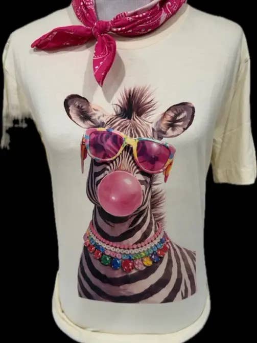 A zebra wearing sunglasses and a colorful beaded necklace blows a bubblegum bubble on a white t-shirt with a jeweled collar.