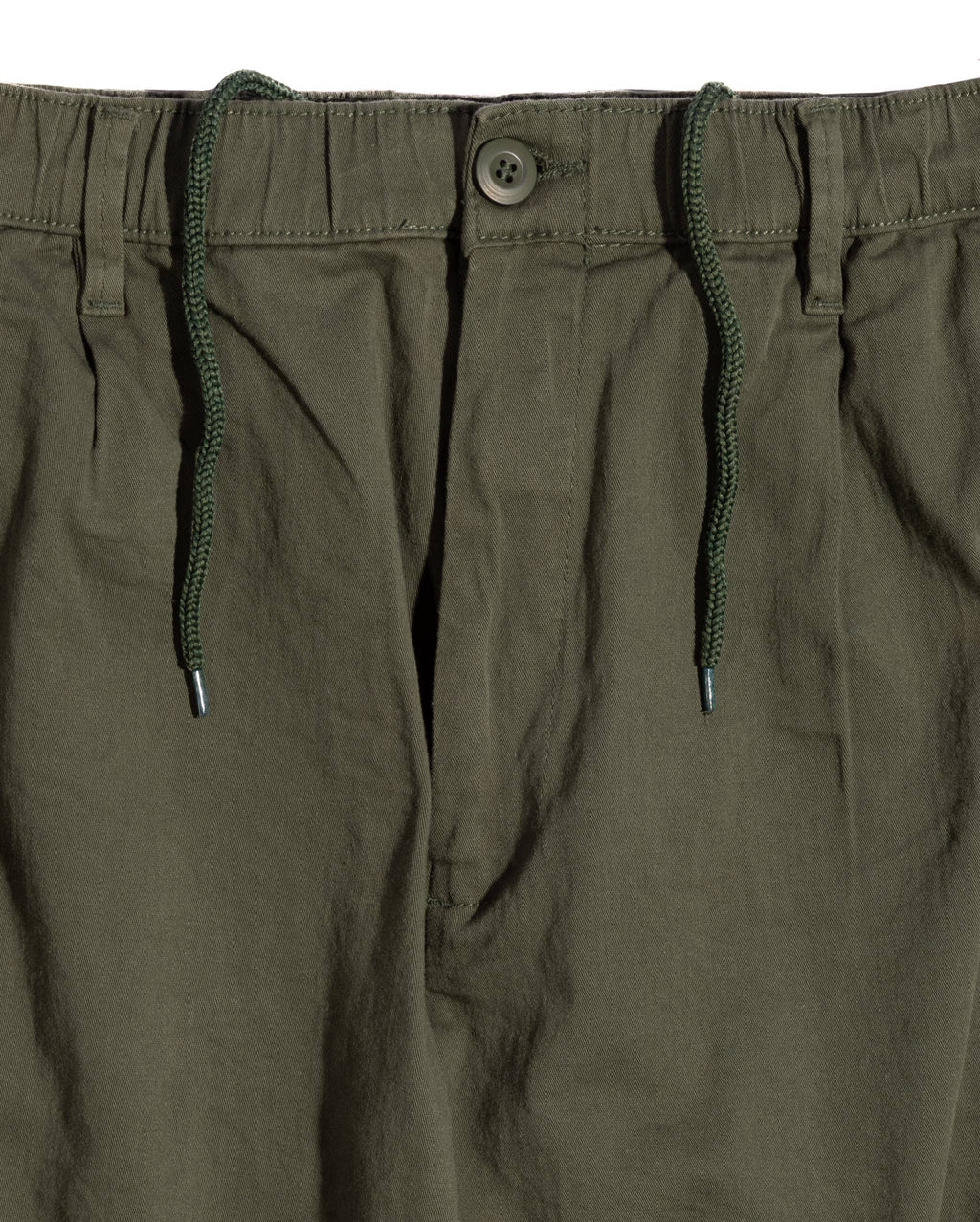 Close-up of relaxed-fit cargo pants showcasing an elastic band with a drawstring, button closure, and pleated front design.