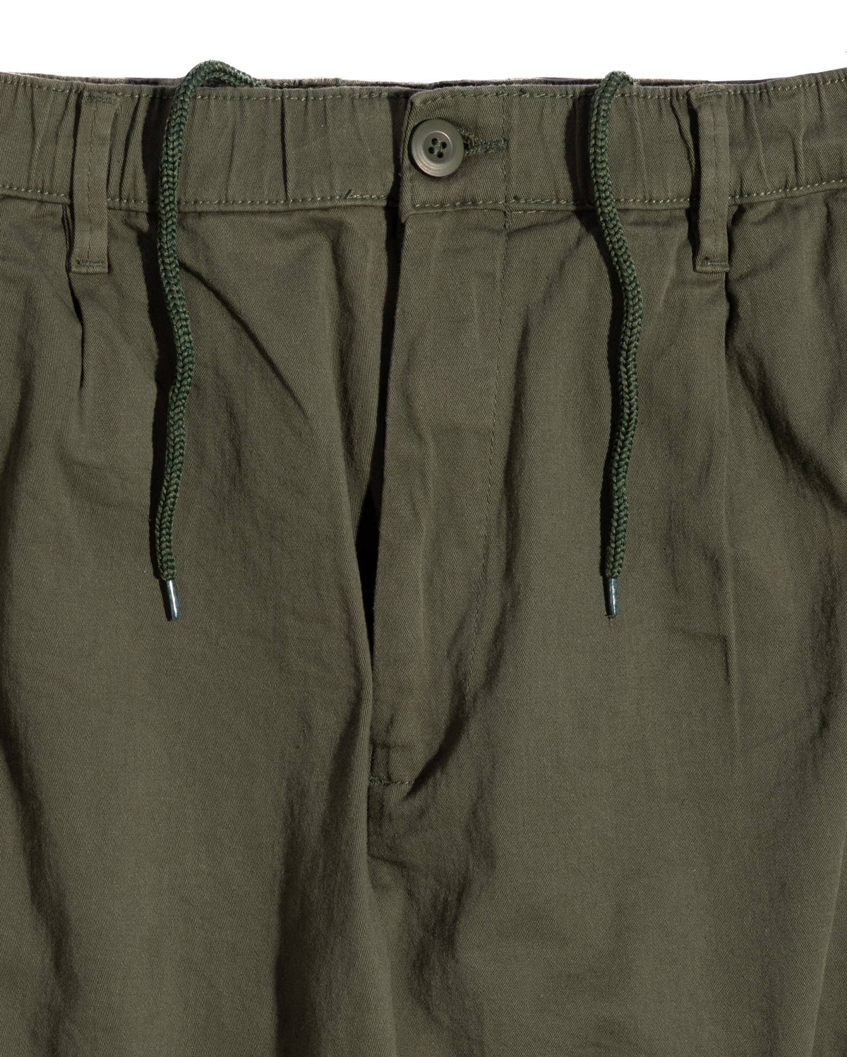 Close-up of relaxed-fit cargo pants showcasing an elastic band with a drawstring, button closure, and pleated front design.