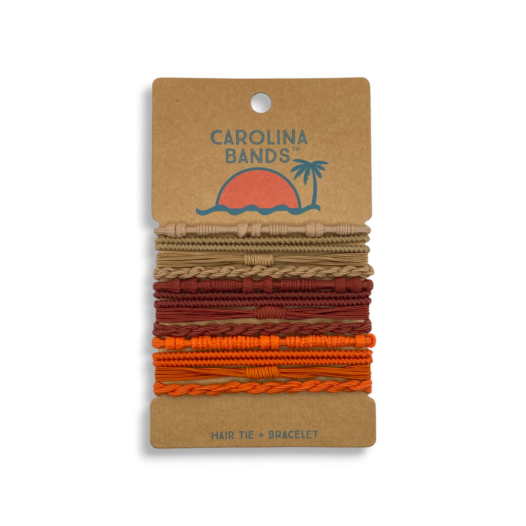 A set of colorful hair tie bracelets in beige, red, and orange displayed on a card featuring a sun and palm tree graphic.