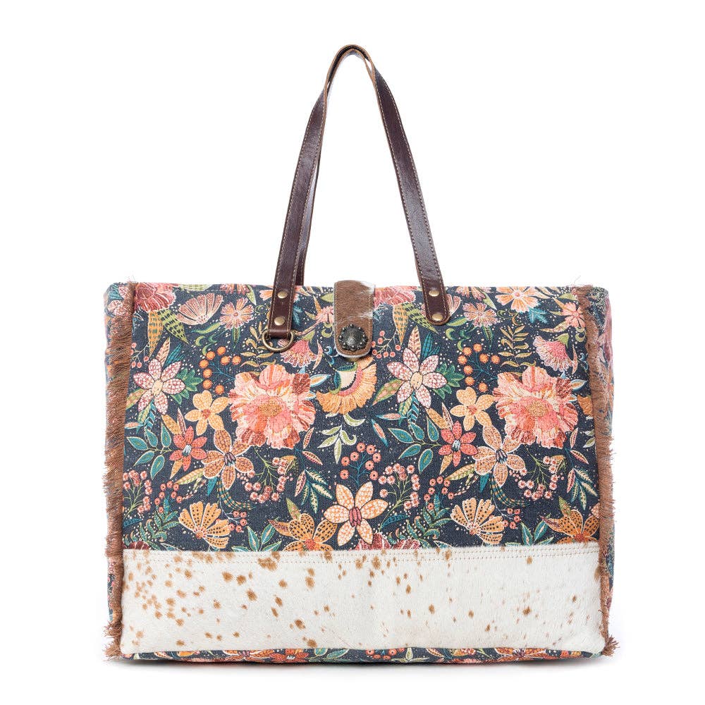 Floral-patterned Fyole Weekender Bag with brown handles and a contrasting lower section, perfect for weekend adventures.