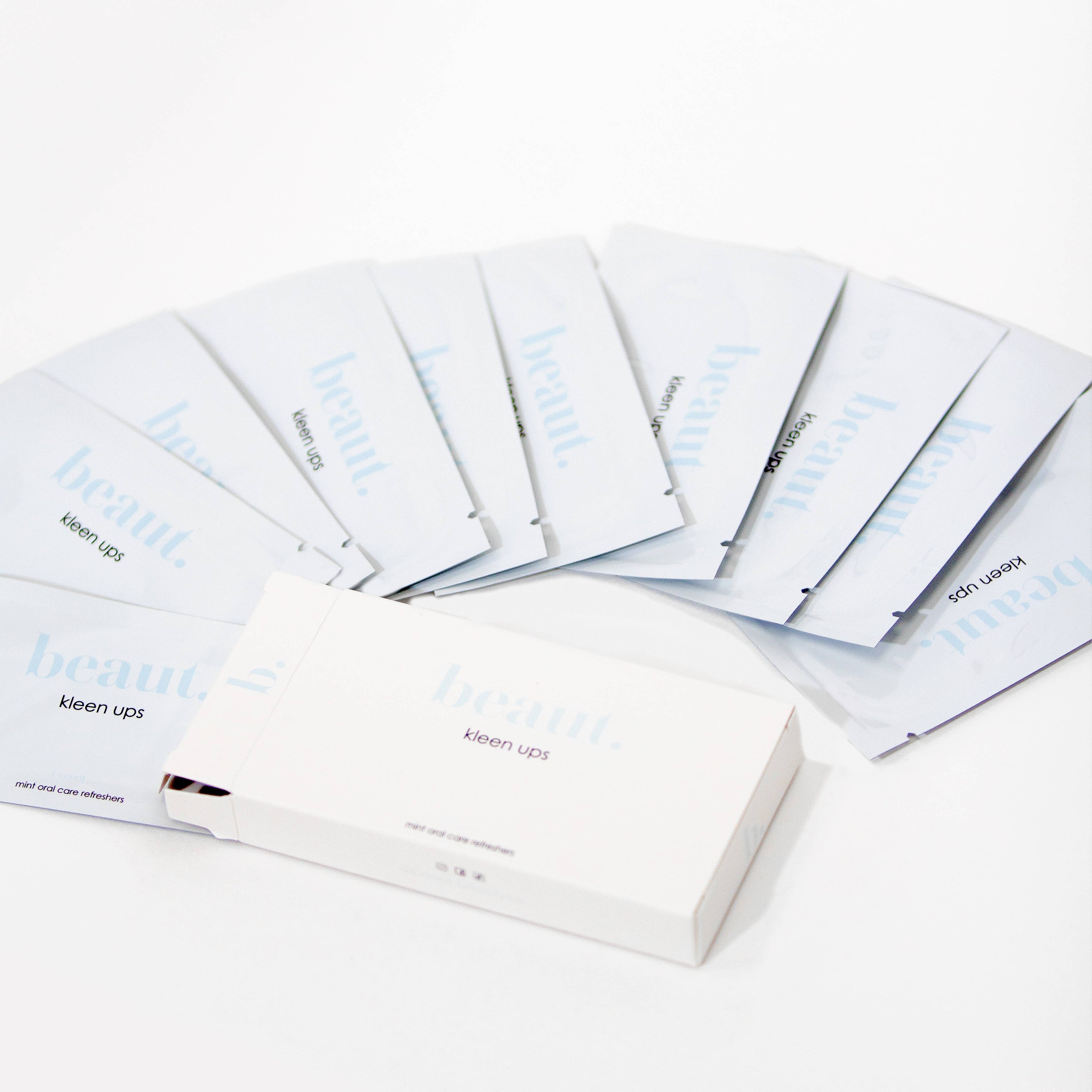 A box of Kleen Ups Mint Oral Care Refreshers Mints with individual packets arranged in a fan display, offering on-the-go freshness.