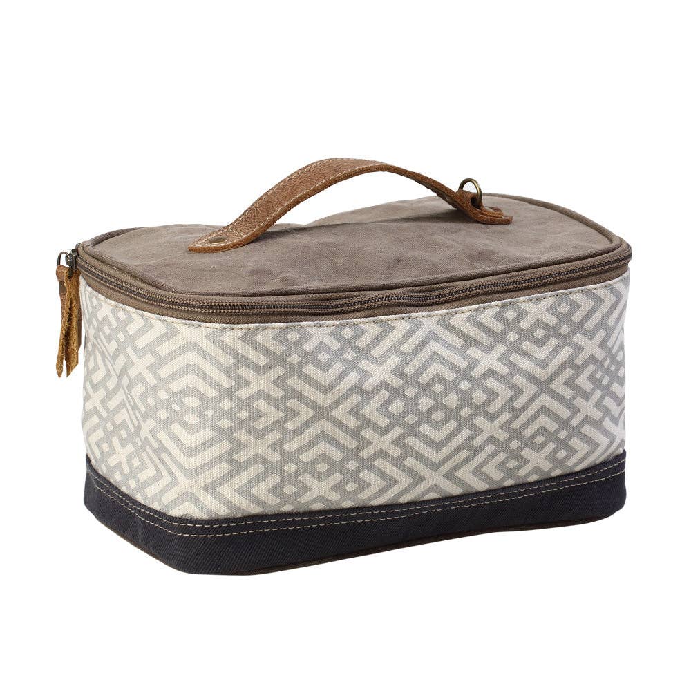Rectangular canvas and leather shaving kit with a wide mouth opening, secure zippered closure, and a leather handle for easy carrying.