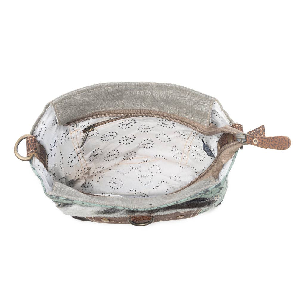Shoulder bag with a structured shape, patterned lining, and zipper compartment, showcasing the stylish Eau De Nil design.