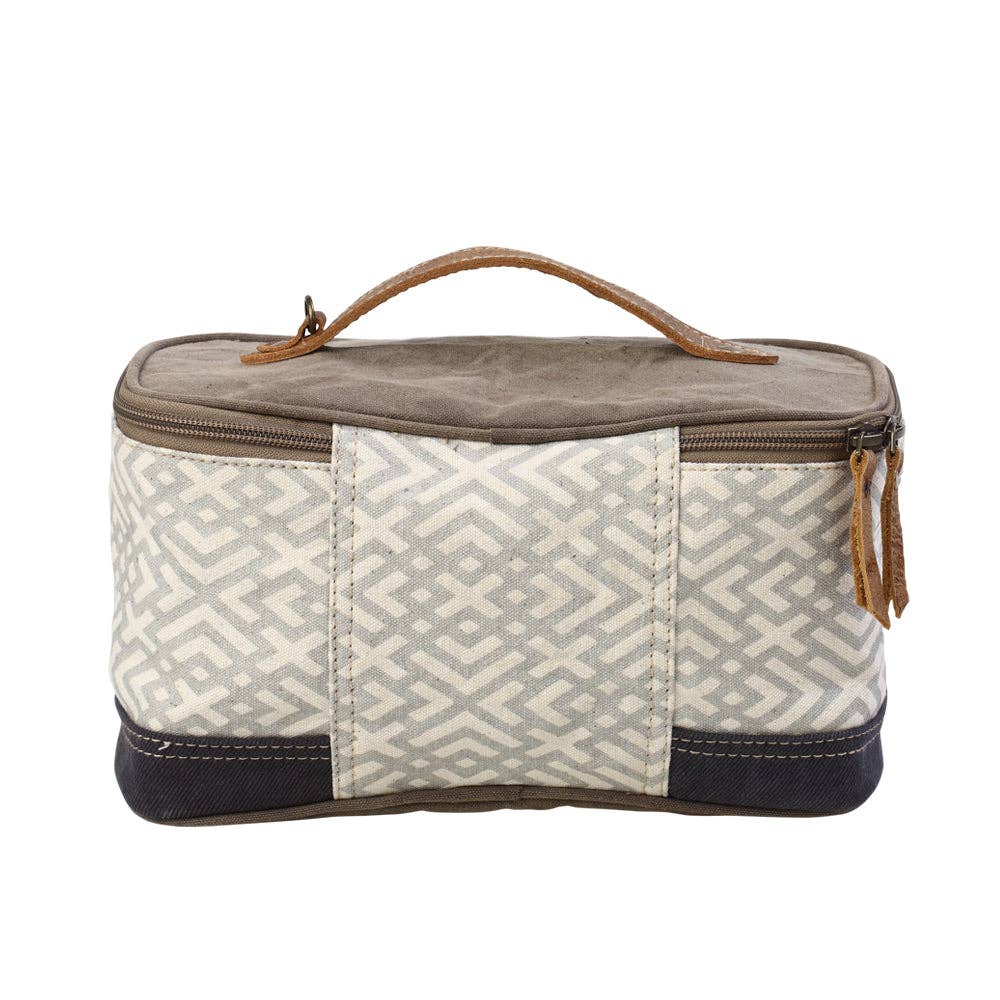 Rectangular canvas and leather shaving kit with a wide mouth opening, secure zippered closure, and top handle for easy carrying.