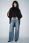 Black chiffon cold-shoulder top with a high-low hem, ruffled cuffs, and a romantic bow tie detail at the back.