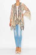 All-lace tiered cardigan with wide sleeves, styled over a light top and fitted jeans in a soft, neutral tone.
