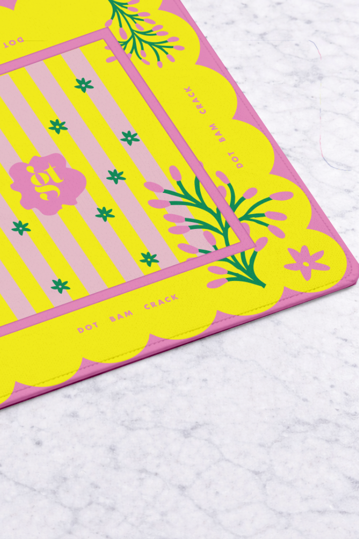 Vibrant yellow Mahjong Mat with pink floral accents and decorative border, perfect for game nights and stylish play.