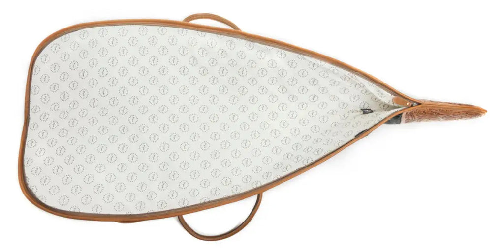 Distinctive hair-on hide rifle case featuring a wrap-around zipper and leather accents, perfect for stylish cowgirls.