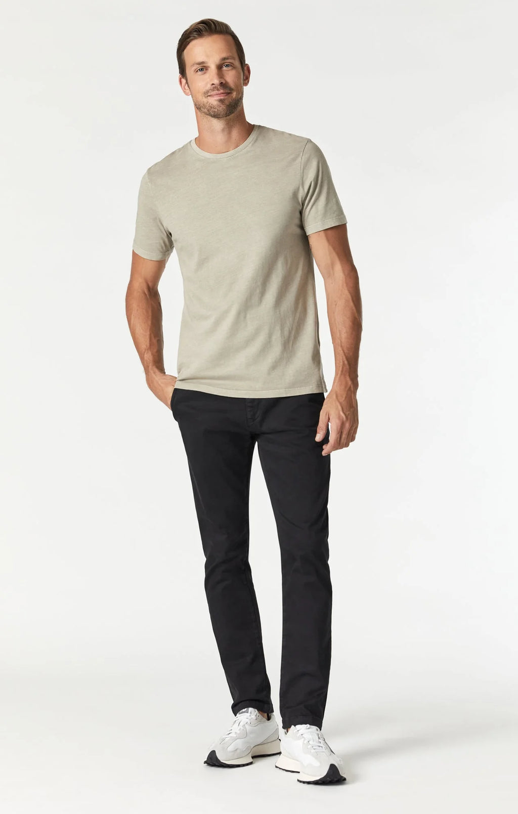 Slim leg chino pants in black with a regular rise, featuring a fitted silhouette through the hip, thigh, and leg opening.