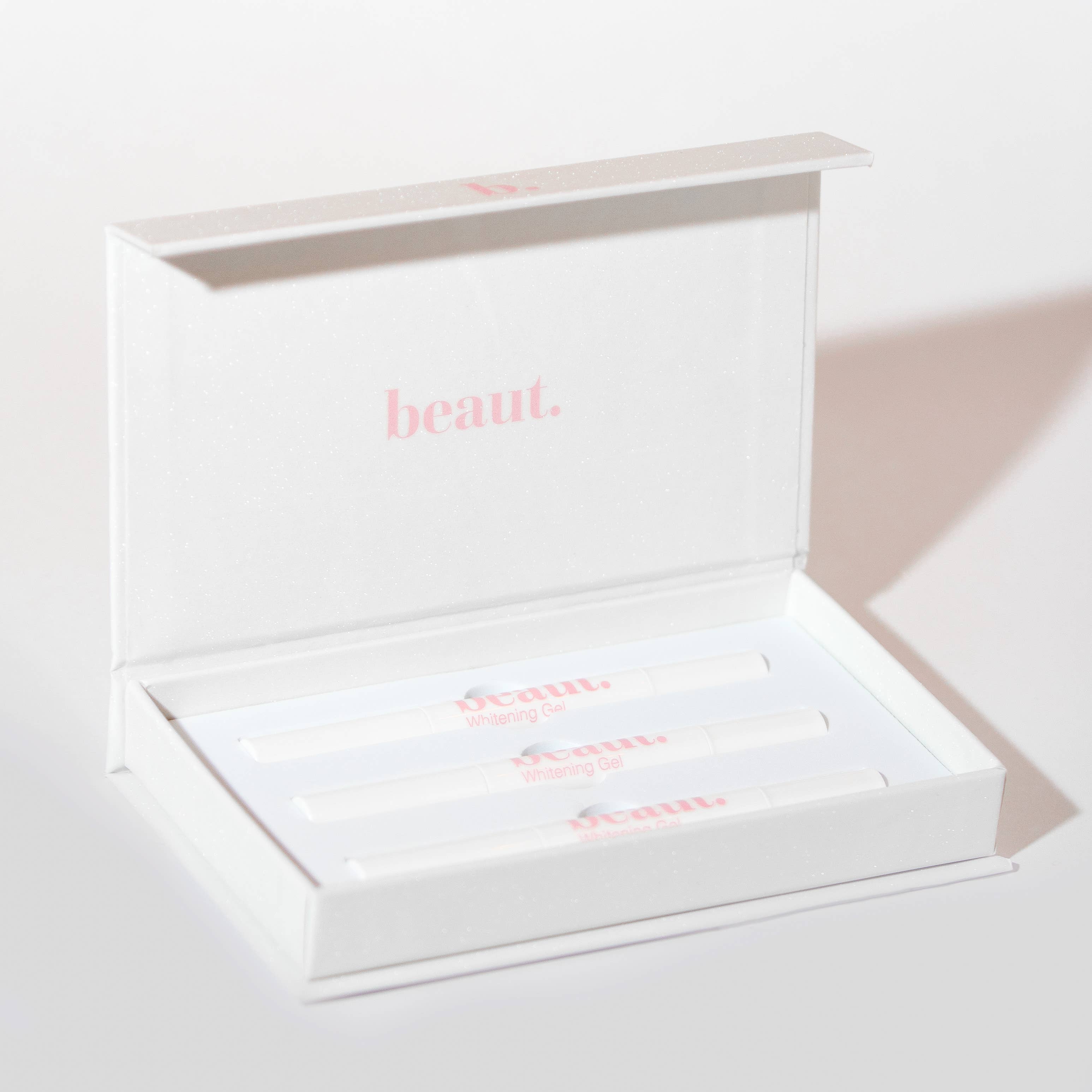 Three smile pens arranged neatly in a white box labeled 'Whitening Gel' from beaut.