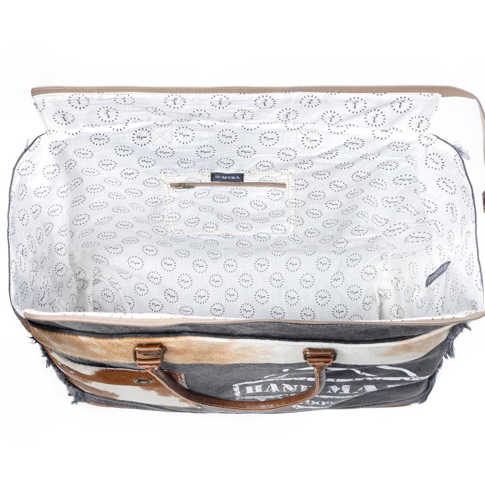 Spacious Handmade Print Weekender Bag with leather top handles and zipper closure, featuring a colorful patterned lining.