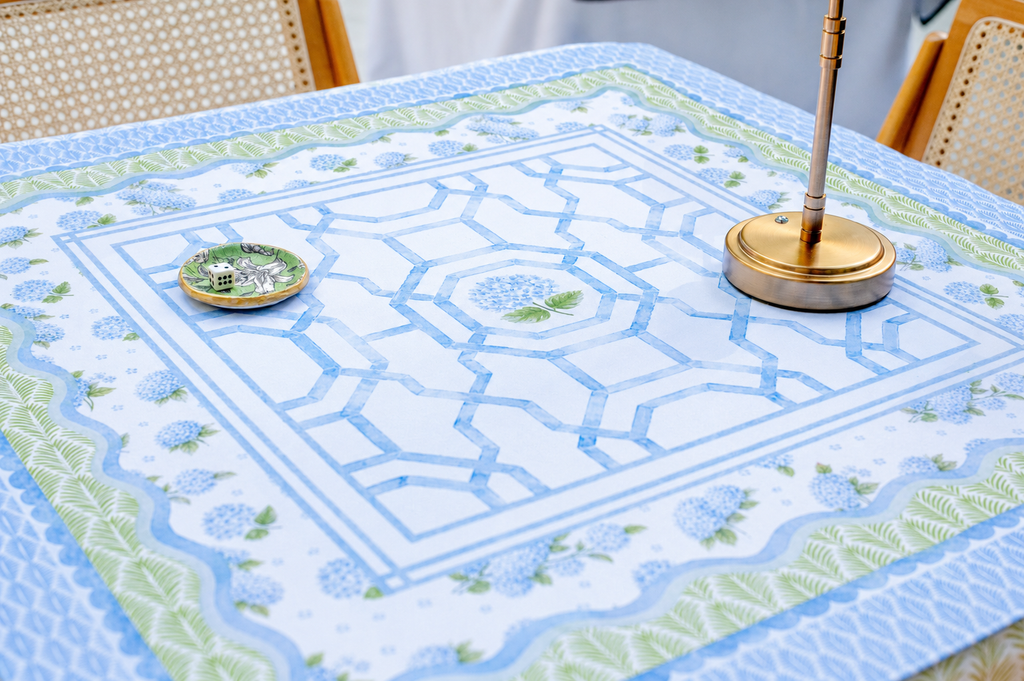 A floral Mahjong mat featuring soft blue and green colors with a scalloped edge and elegant lattice details.