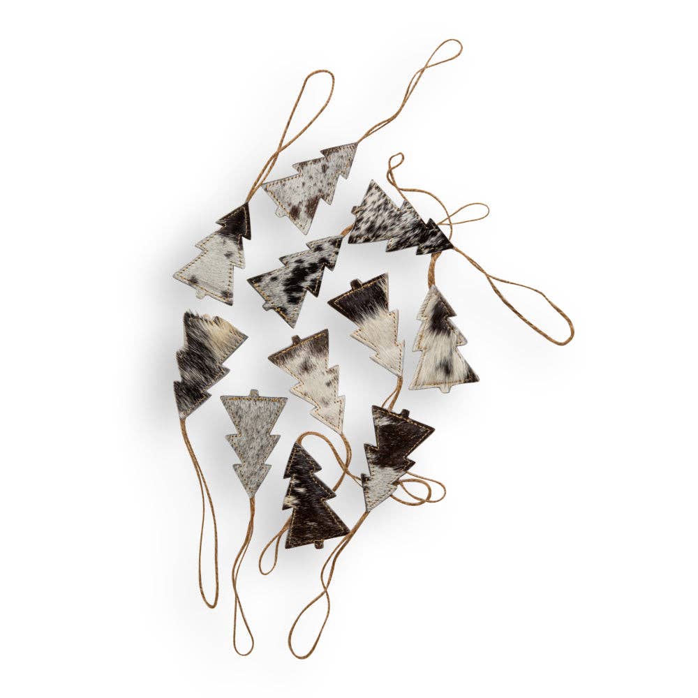 A set of ten unique black hair-on hide Christmas tree ornaments with natural jute hangers, arranged in a scattered layout.